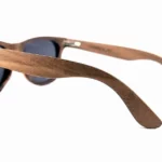 Vue rapprochée des lunettes Howker Grey, présentant des veines naturelles uniques du bois de noyer.