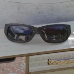 Lunettes de soleil en bois d’ébène modèle Mirage – Vue de face sur meuble multicolore